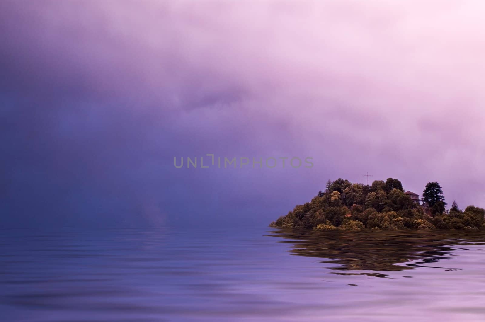 Mountain top with cross surrounded by flood with dramatic sky and copy space