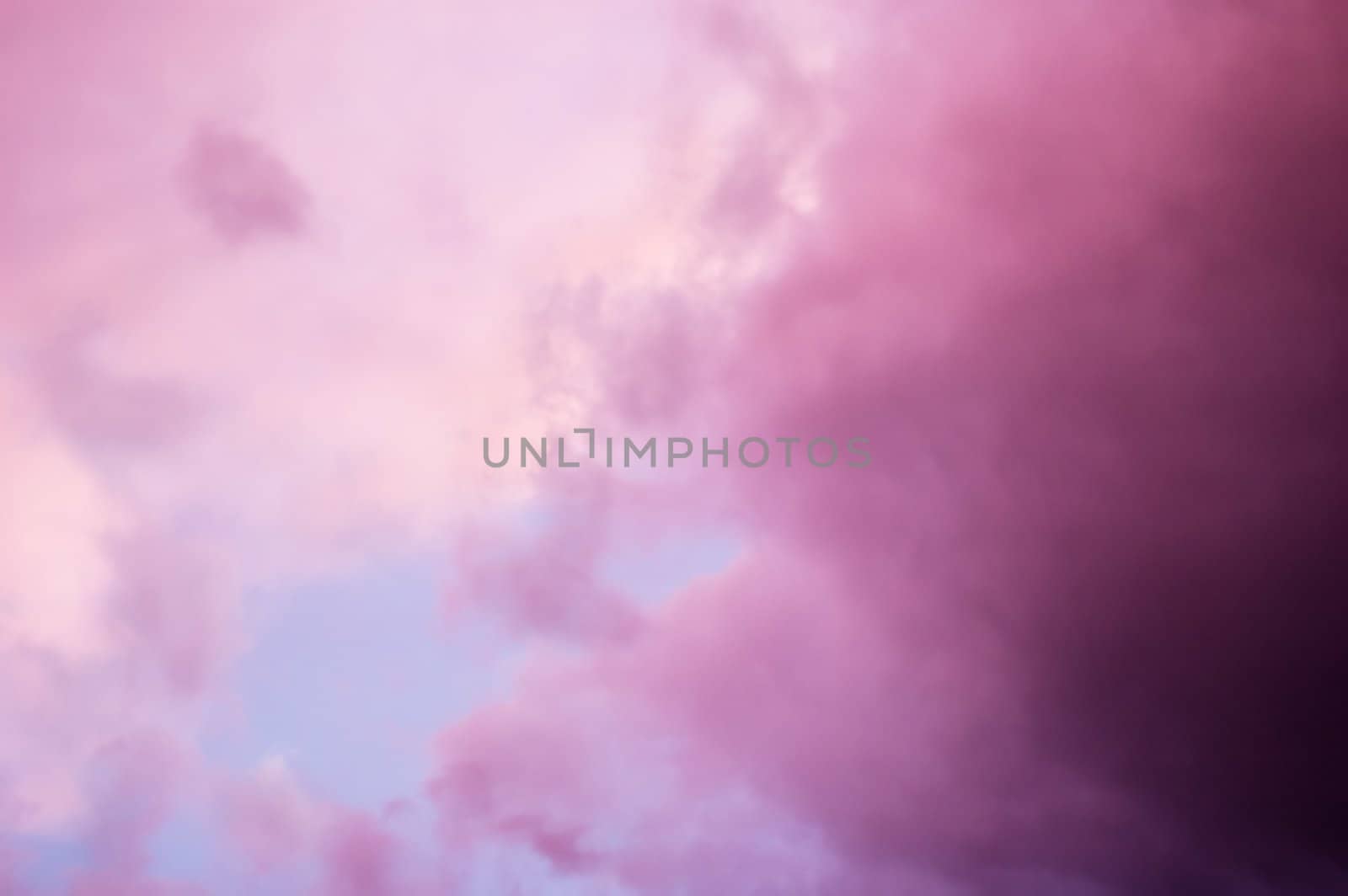 Dramatic pink clouds at sunset with soft focus for dreamy look