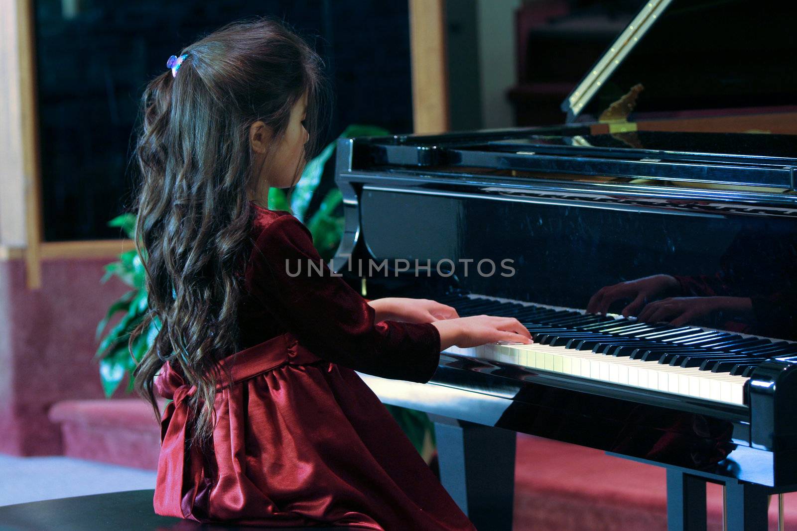 Child playing grand piano