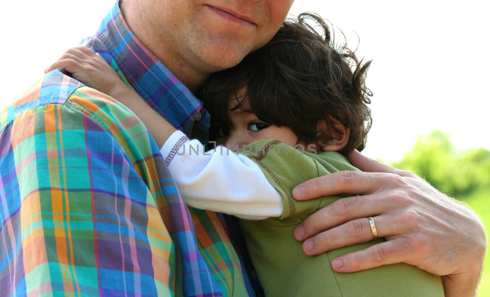 Father holding son outdoors