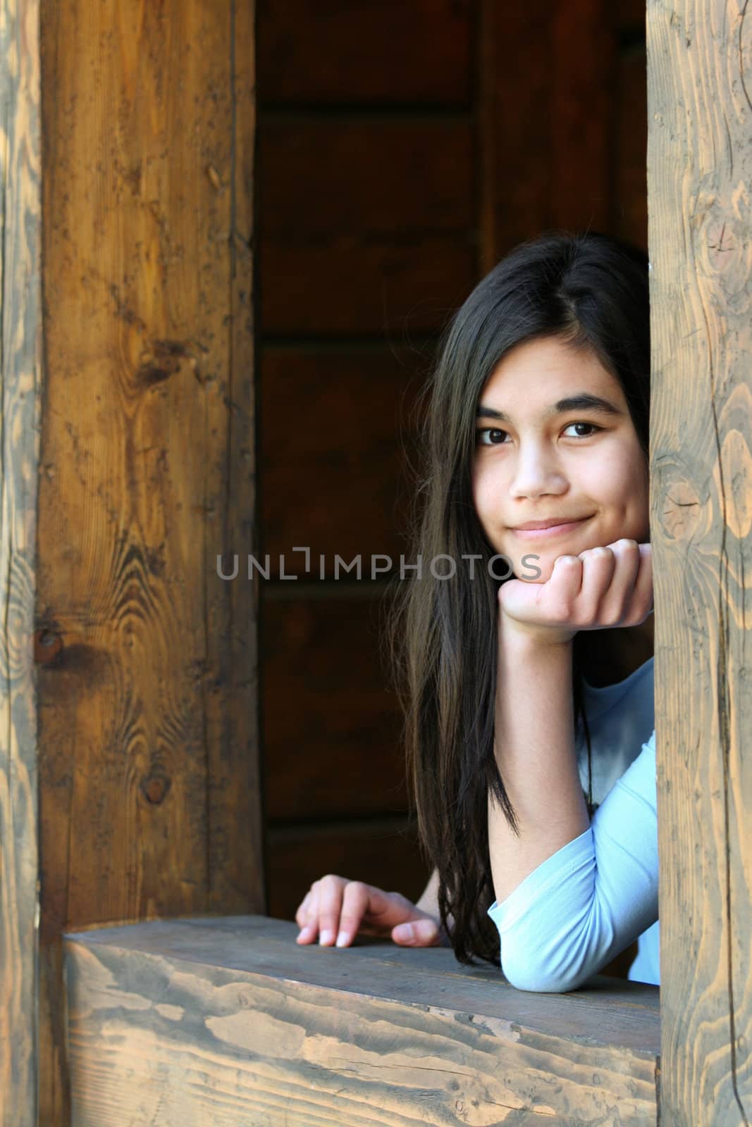 Beautiful young teen girl relaxing on porch, part asian, scandinavian background