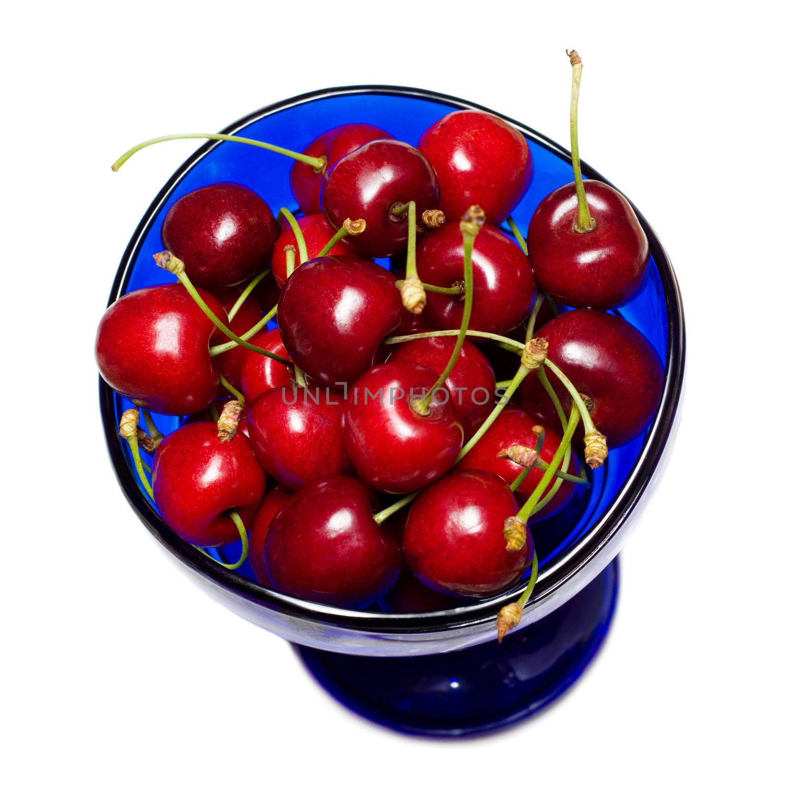 ripe sweet cherries in blue cup by starush