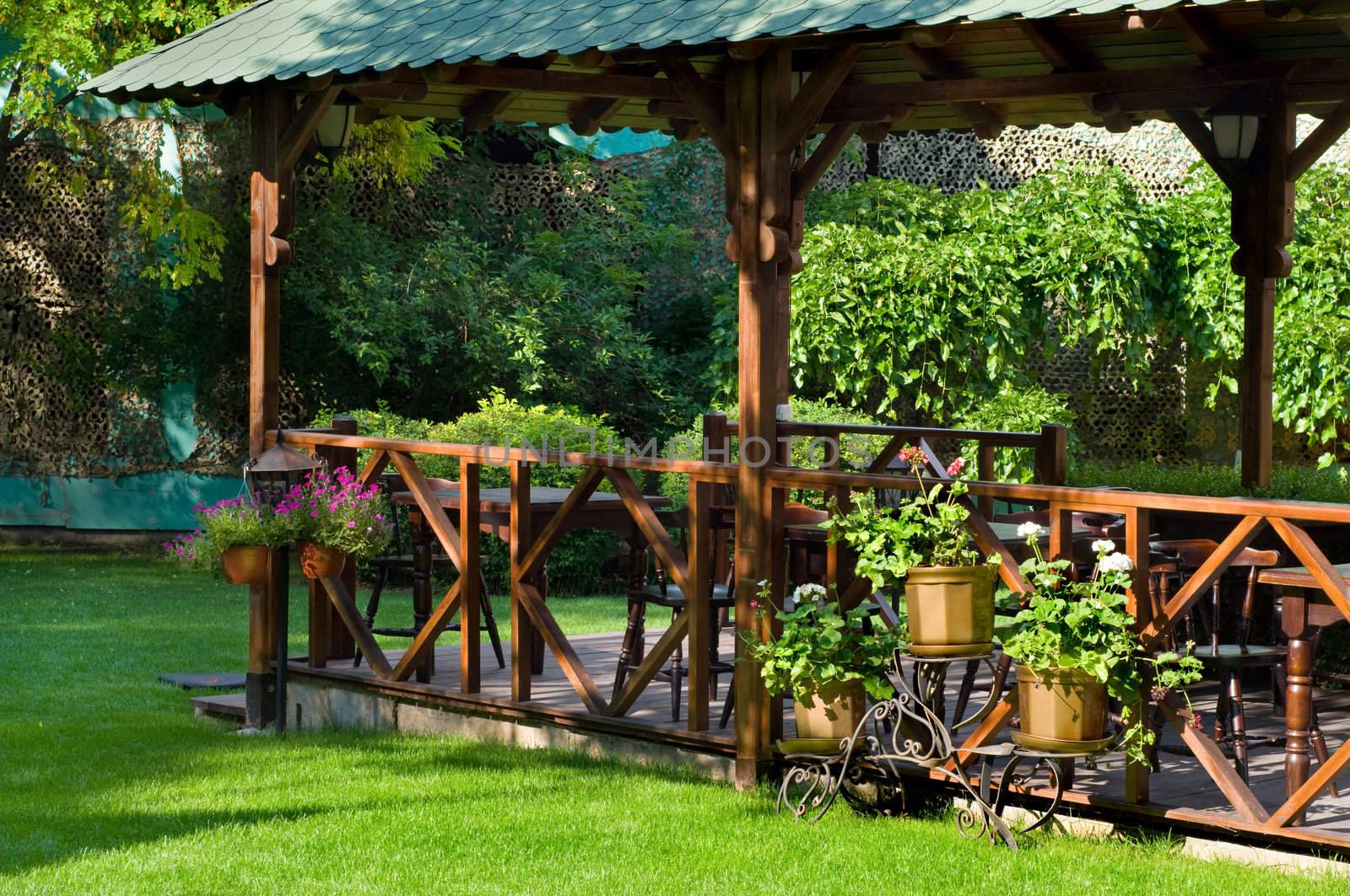 empty well decorated open air cafe with lots of green plants