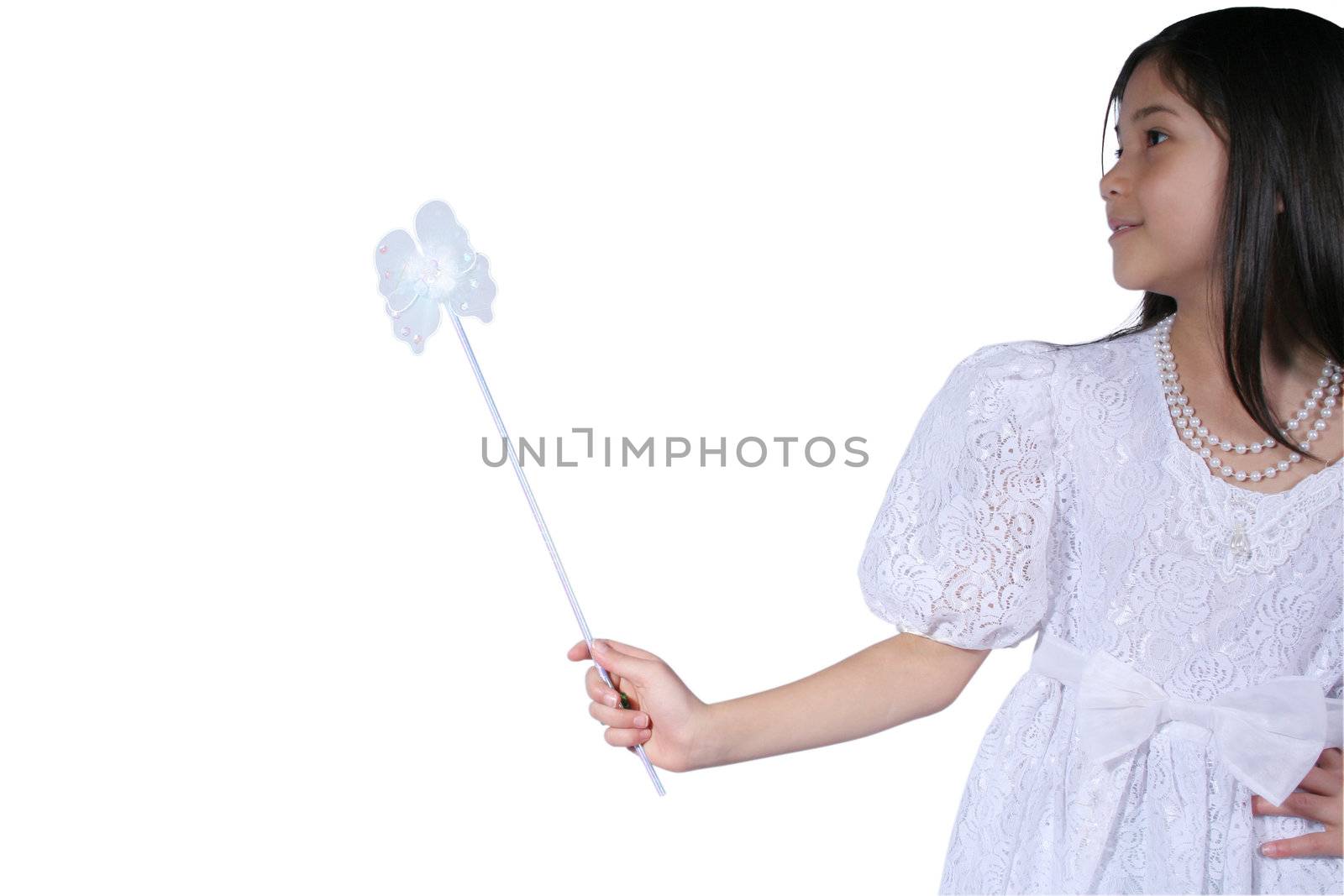 Little girl dressed in gown and holding wand