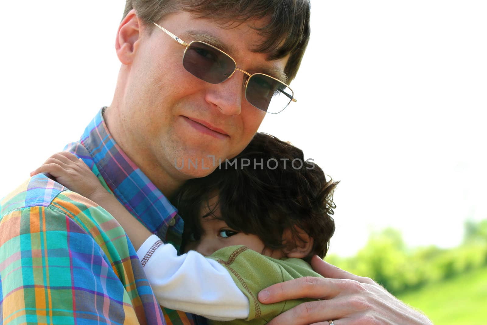 Father holding son outdoors