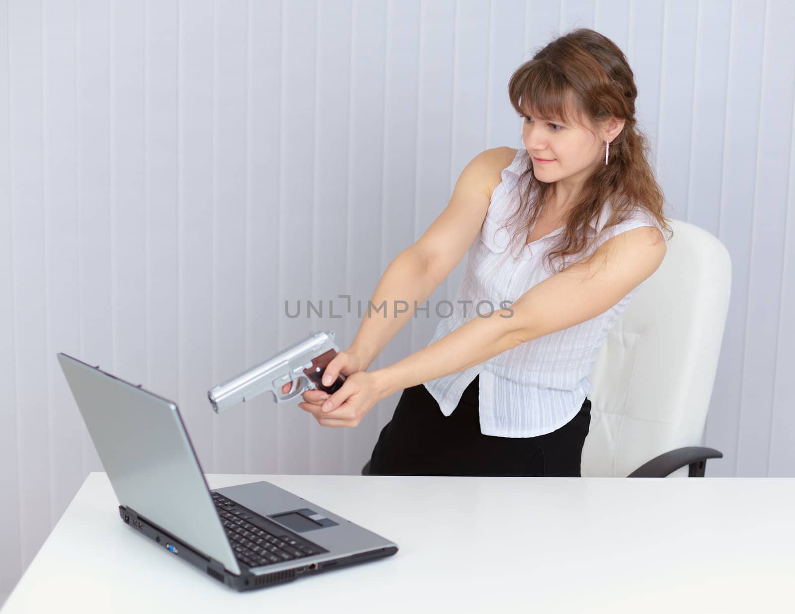 The woman calmly fired a pistol at a computer screen