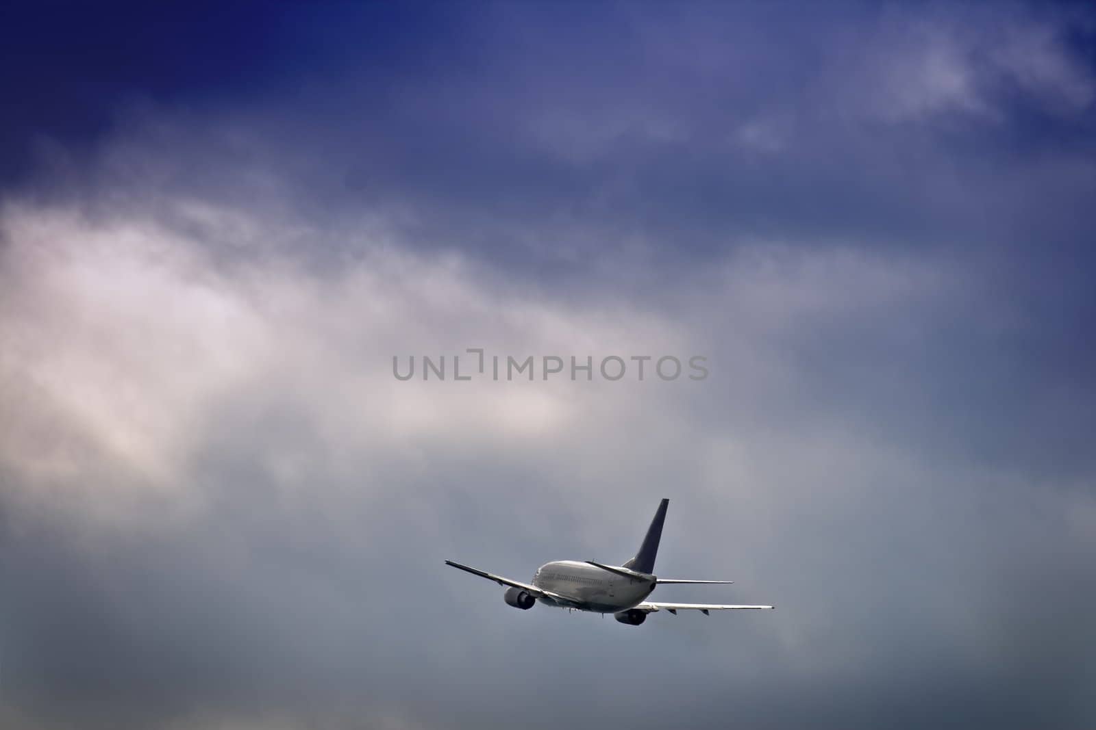 Jet airliner against stormy sky
