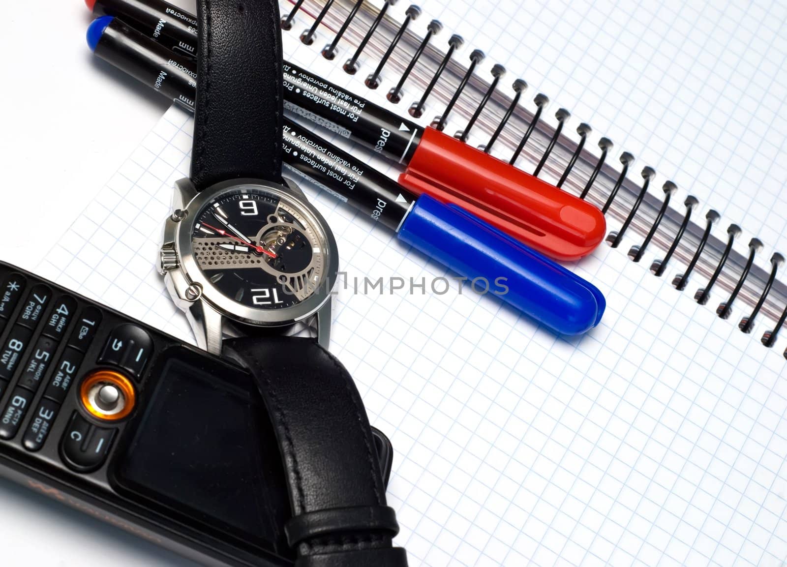 two pens, watch, notebook, cellular phone