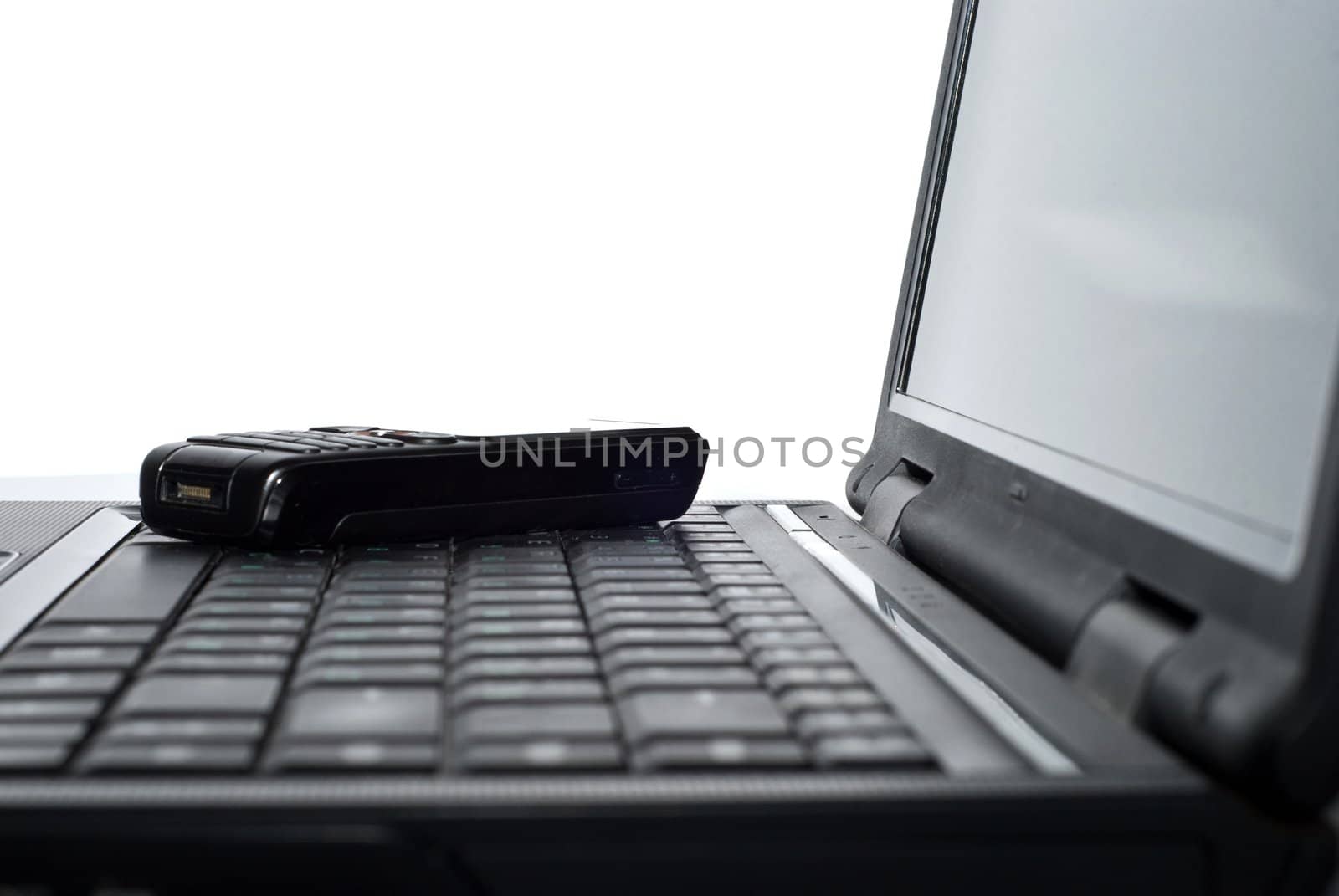 Cellular phone on a laptop