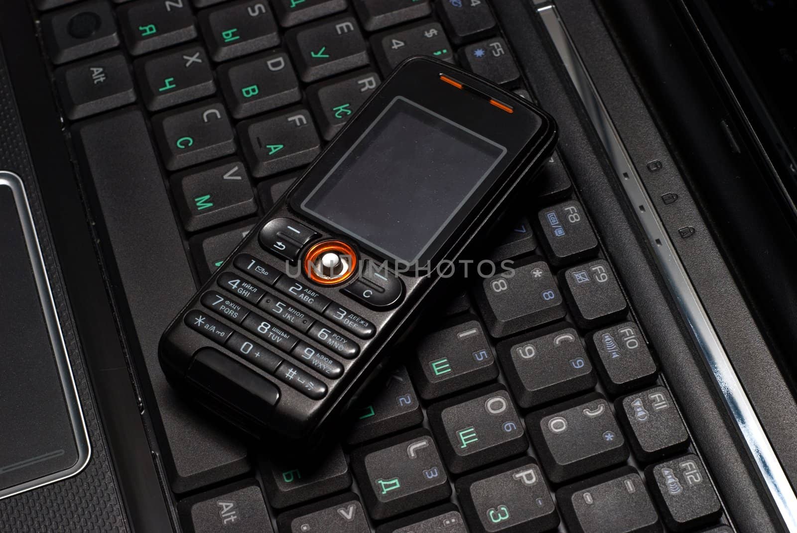 Cellular phone on a laptop