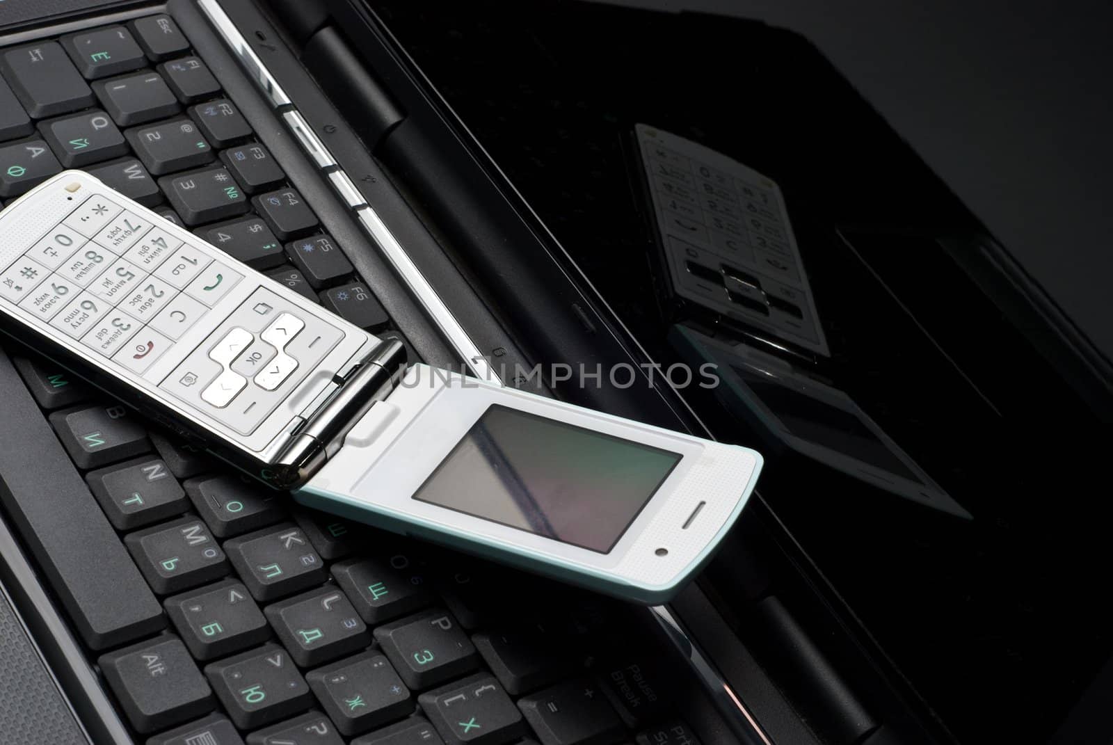 Cellular phone on a laptop