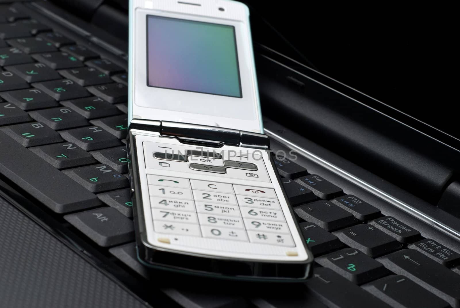Cellular phone on a laptop