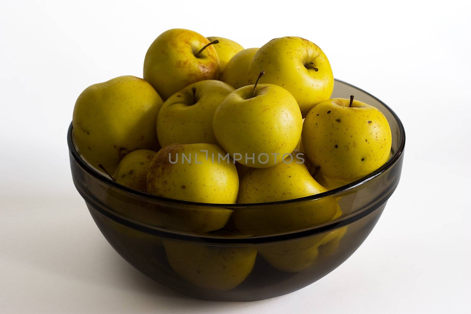 Ecological yellow apples in glass bowl on white background (clipping path included)