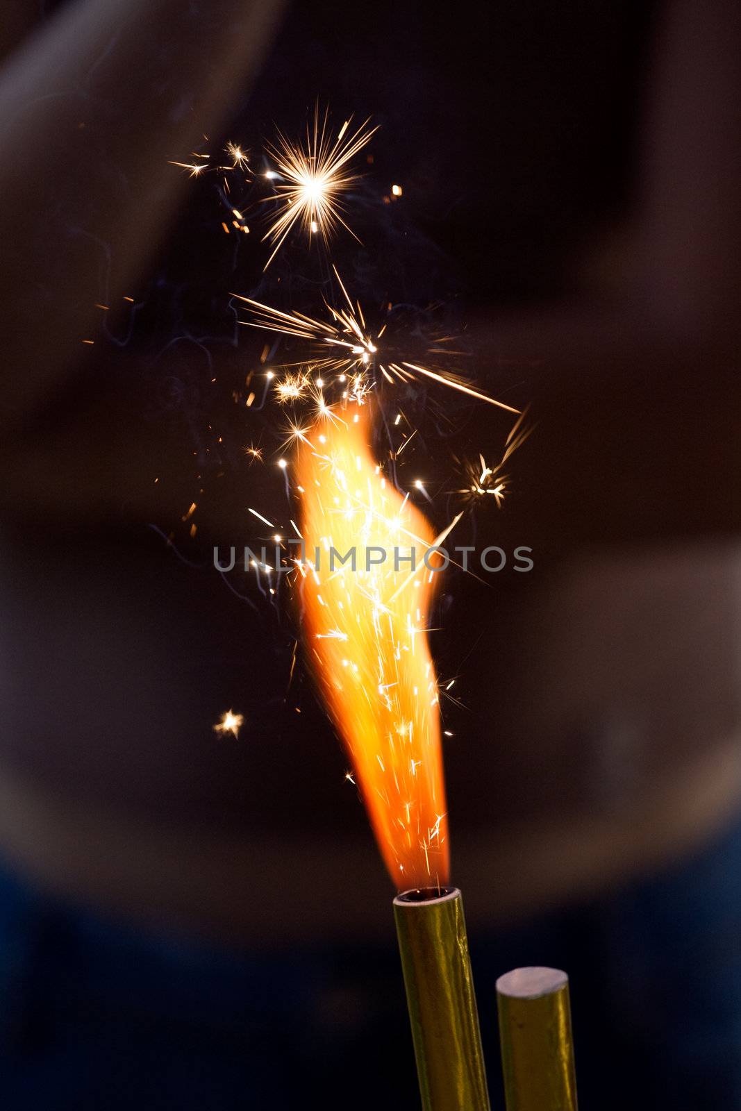Burning birthday cake sparkler. Flame with branching white sparks.