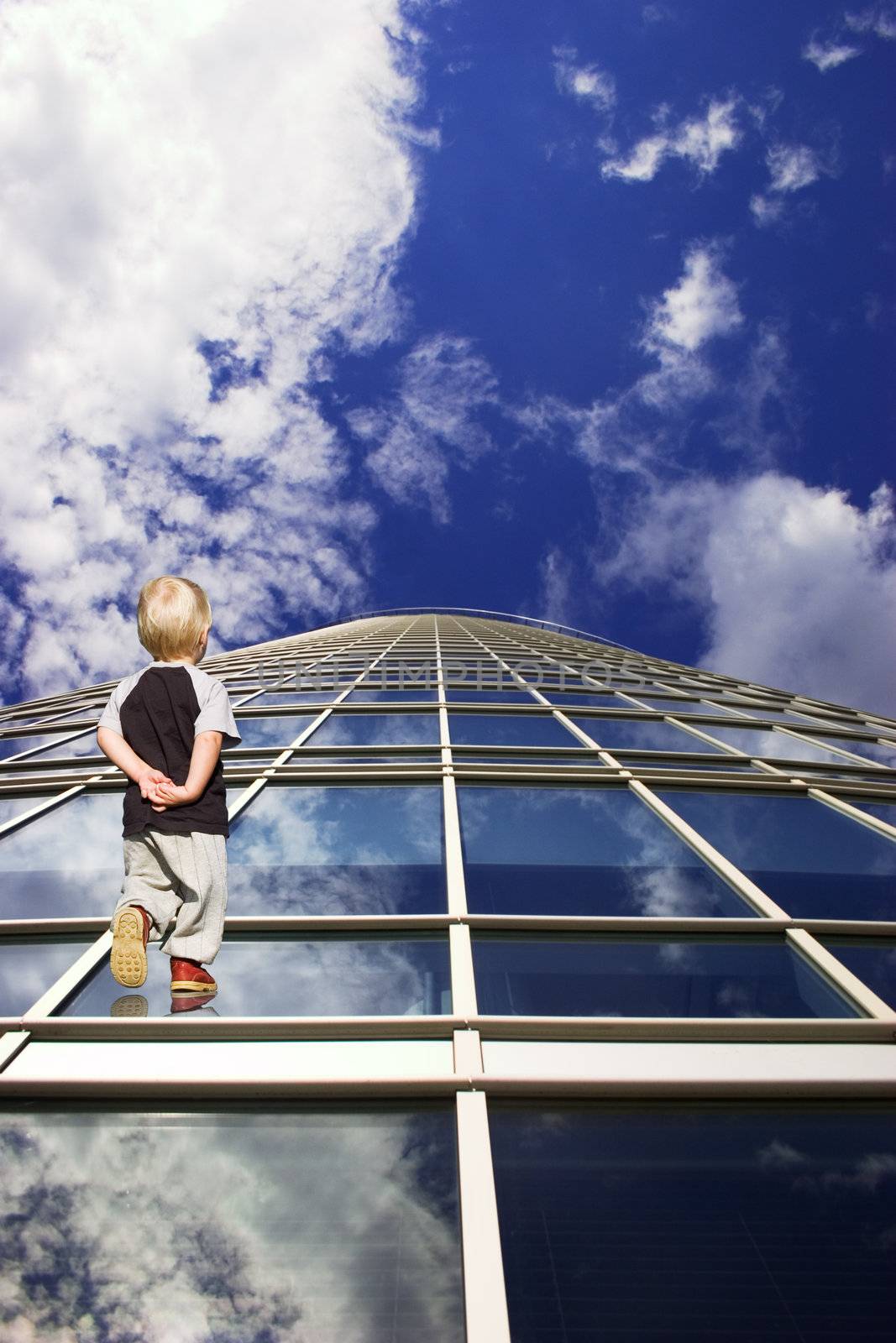 Child and his path to future. Perspective of skyscraper windows