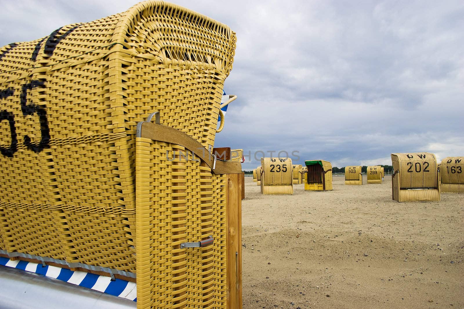 Beach wicker chairs with numbers on back in Germany near Baltic sea