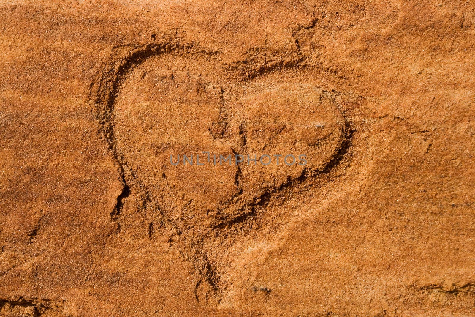 Heart scraped into sandstone by ints