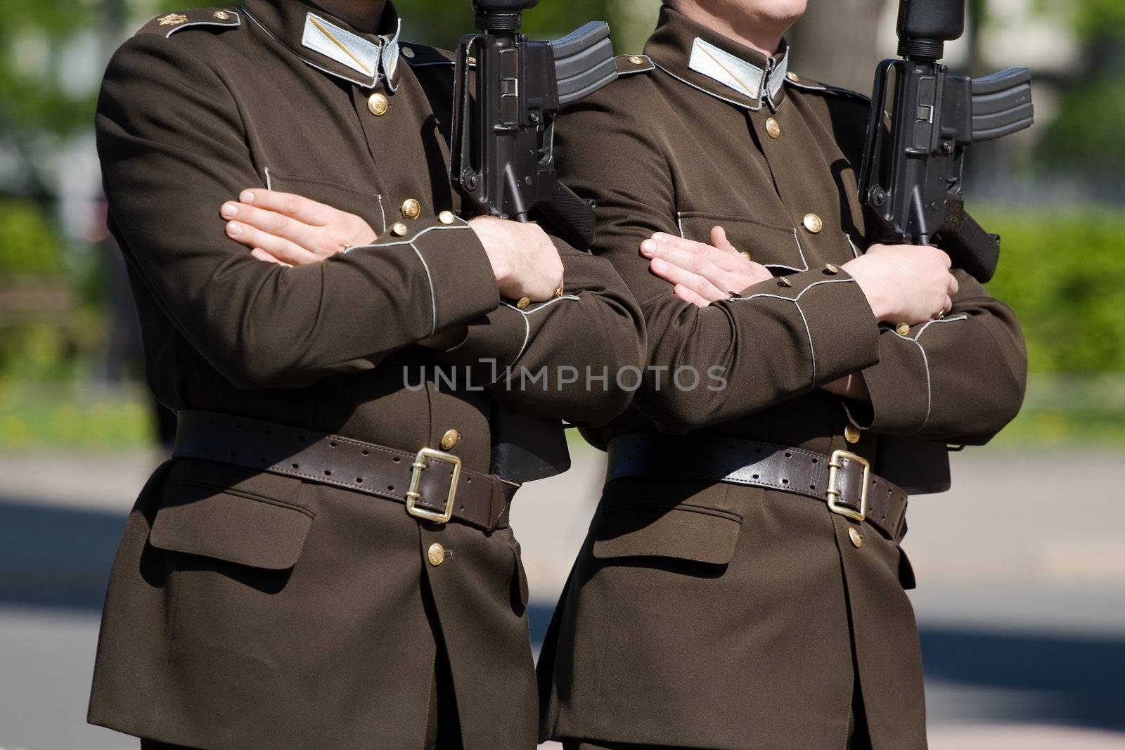Two latvian honor guards with rifles marching