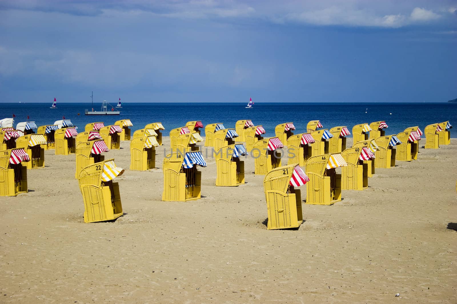 Beach wicker chairs near sea by ints