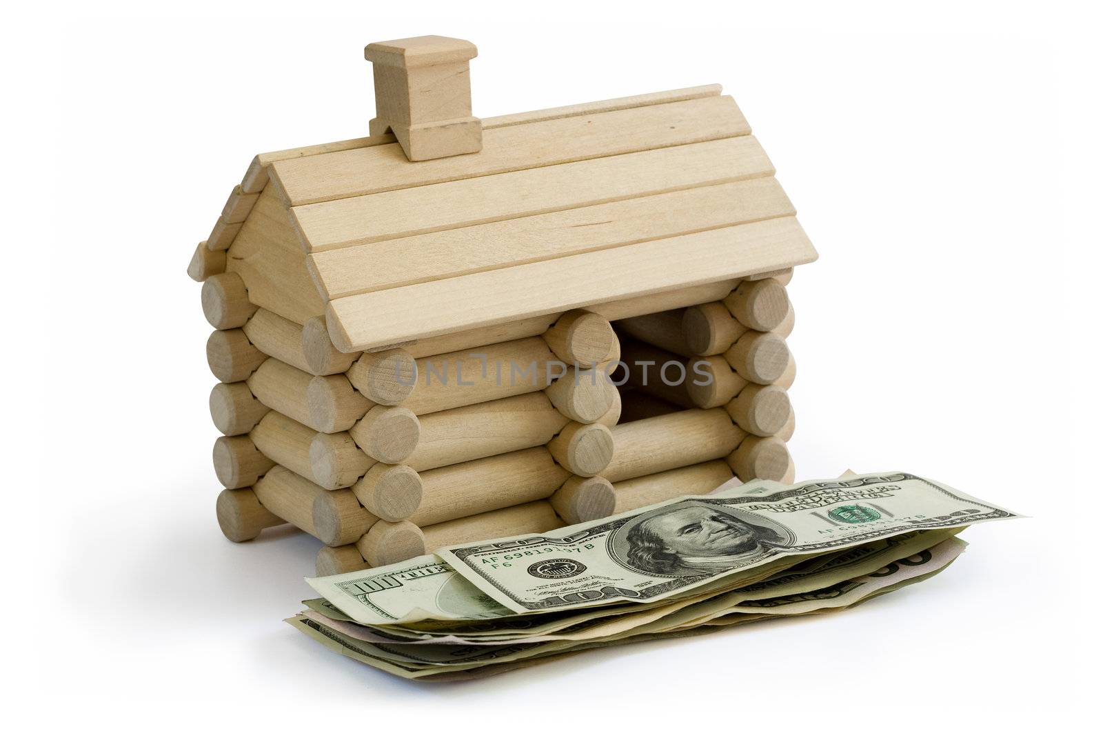 Miniature Log House building model and money dollar bills in foreground. Clipping path included to remove object shadow or replace background.