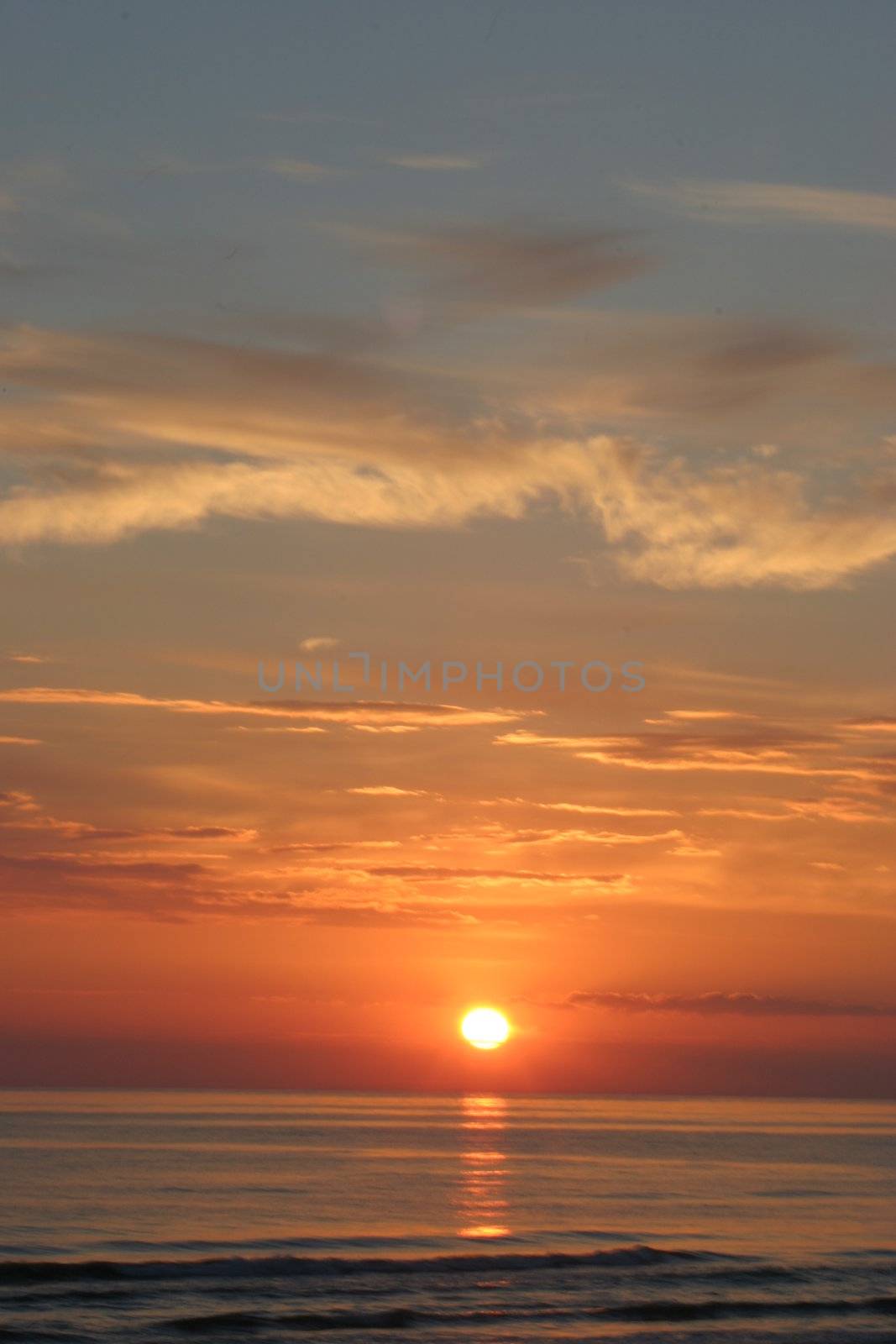 Sunset skies with clouds over sea