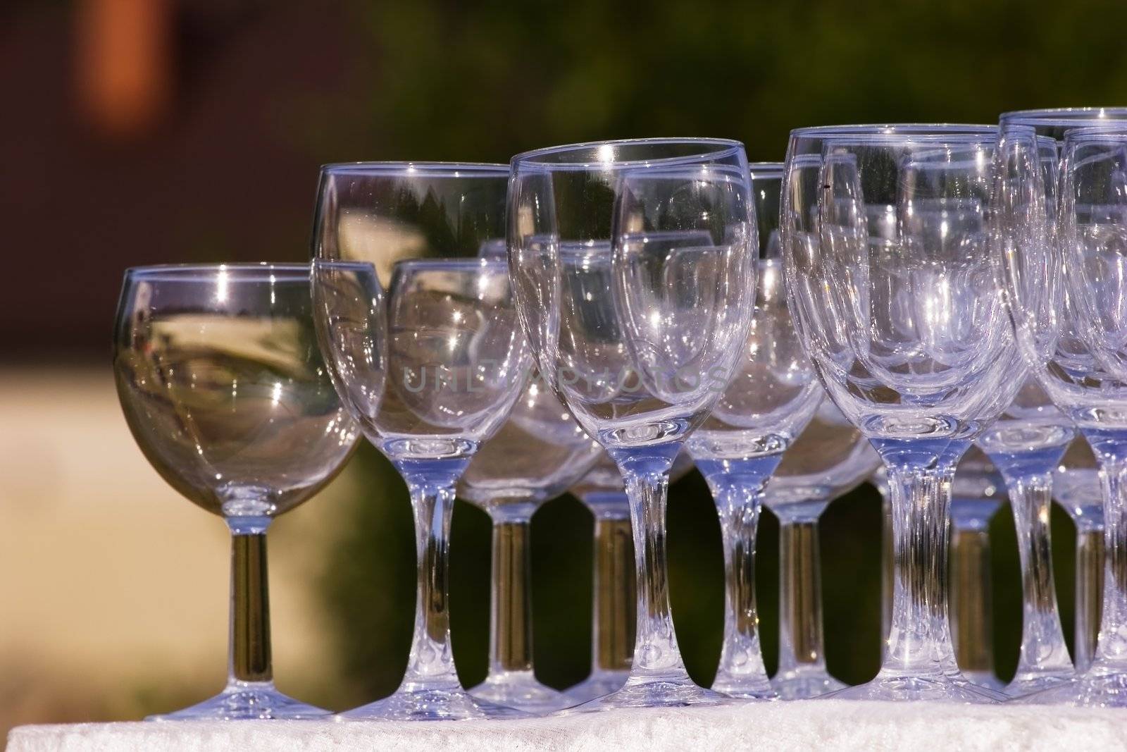 Arranged empty champagne (wine) glasses. Summer, outdoors.