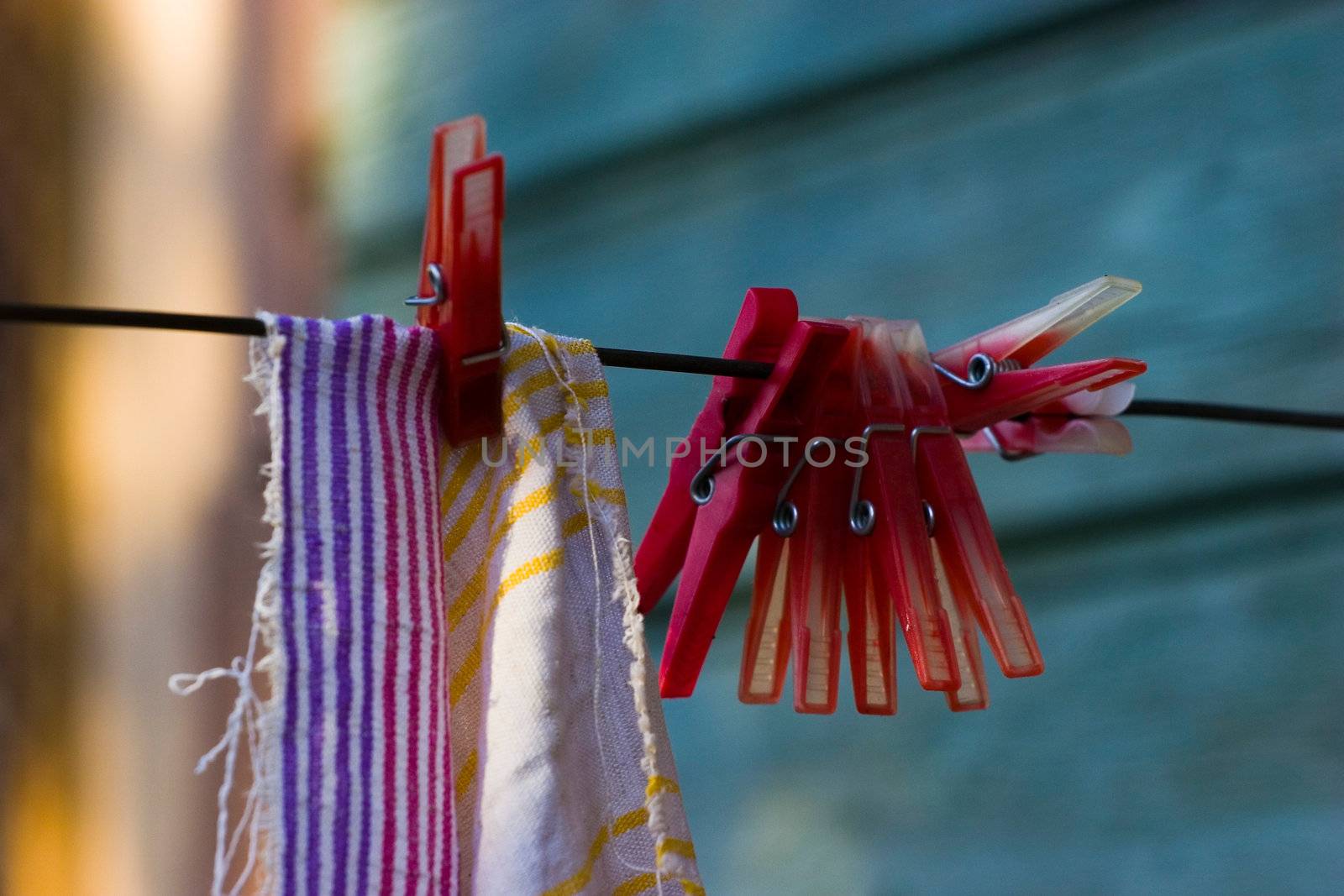 Red plastic clothespins and towel by ints