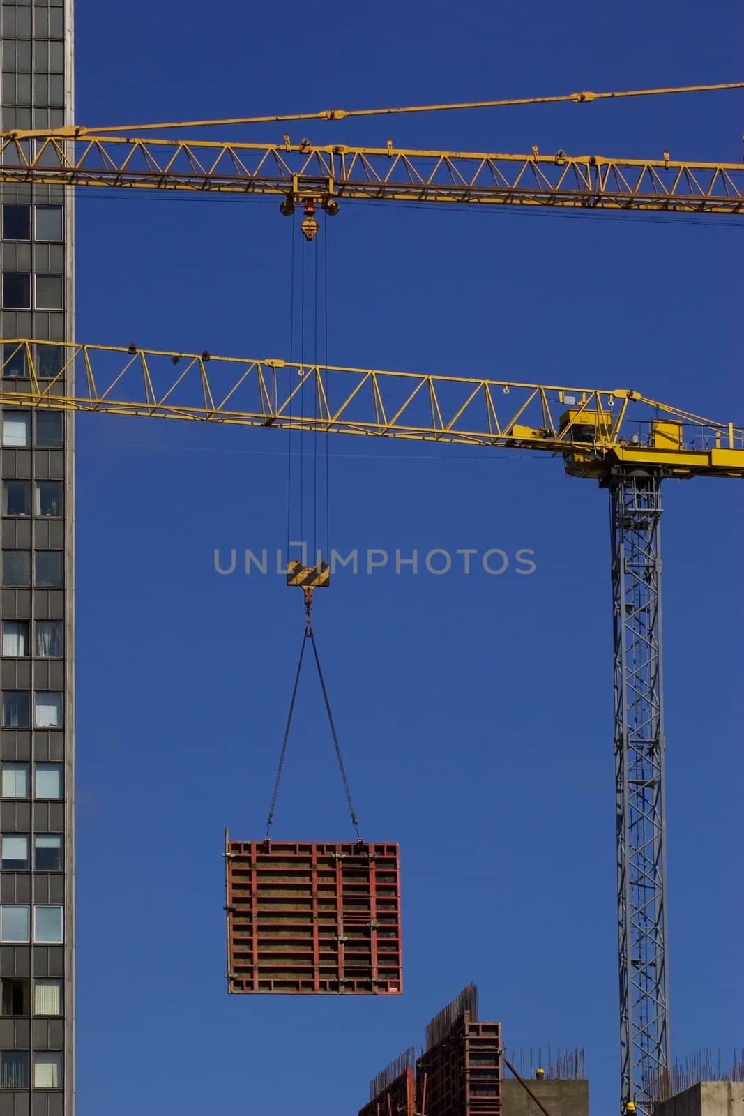 Construction crane lifting concrate frame