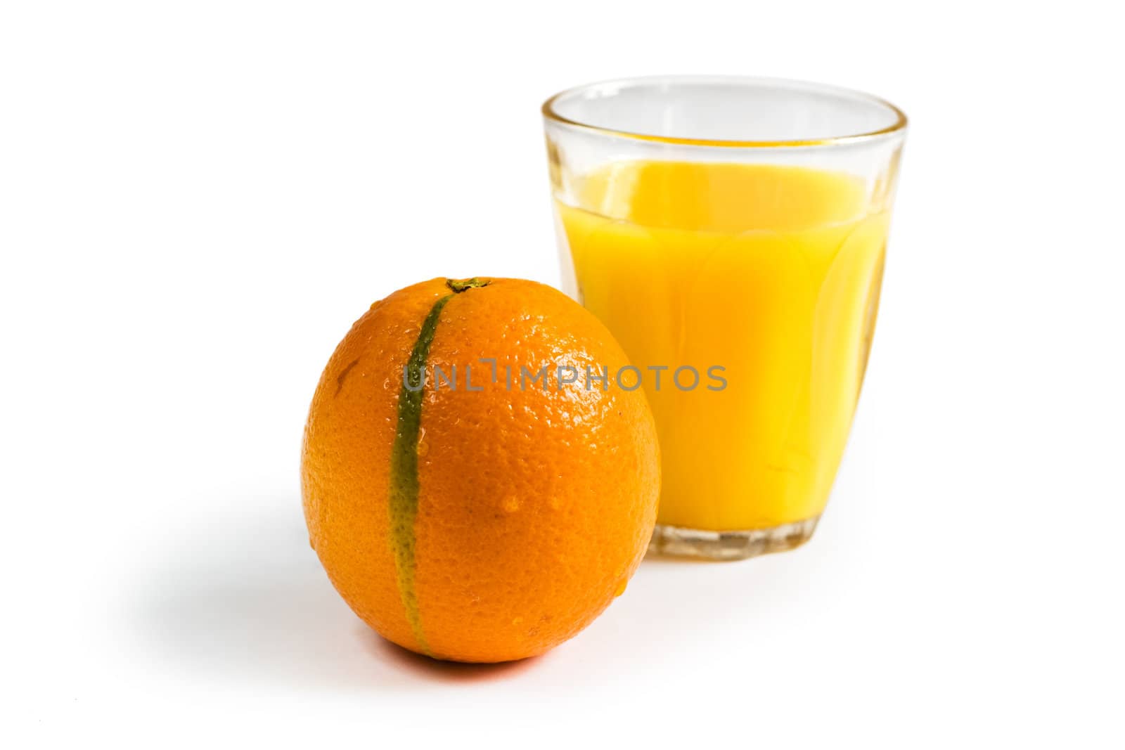 A Glass of Orange juice in background with Fruits in foreground. Clipping path included