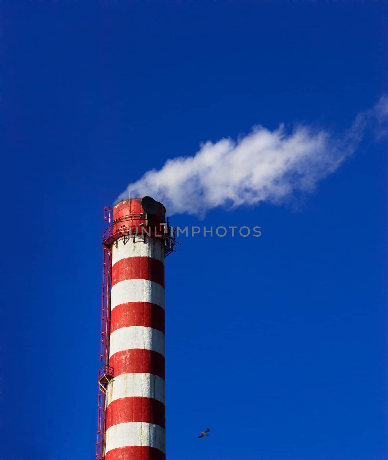 heating plant chimney white smoke with blue sky