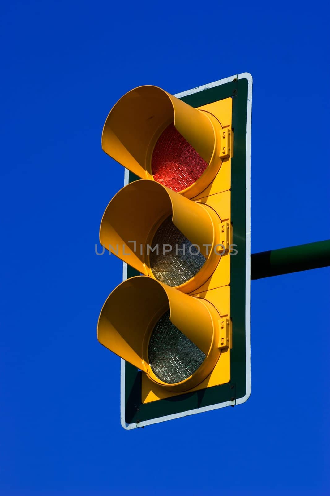 Red stop traffic light on blue sky