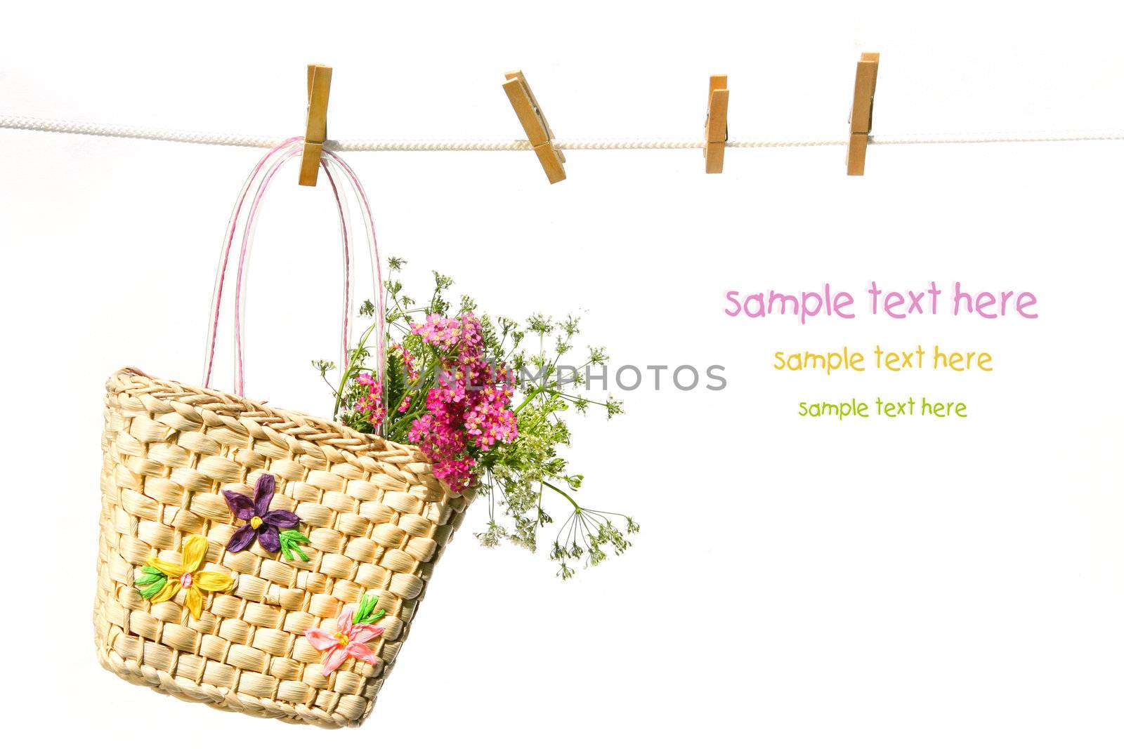 Child's straw purse with flowers on clothesline