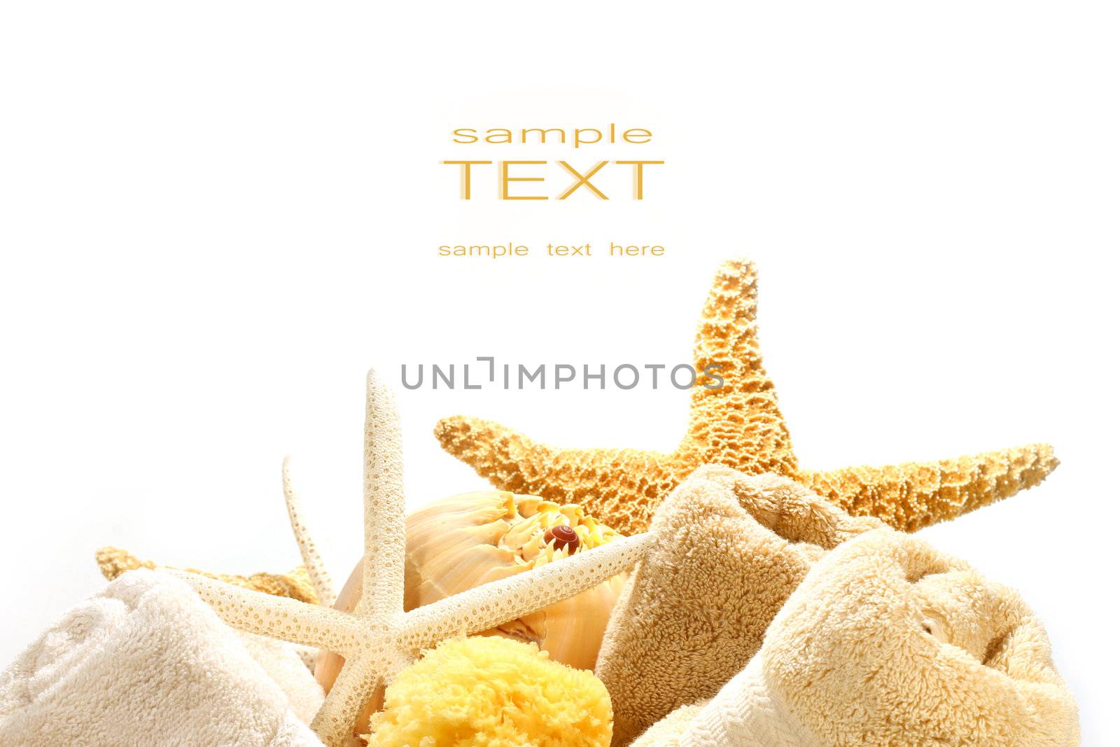 Assorted towels and starfish against a white background