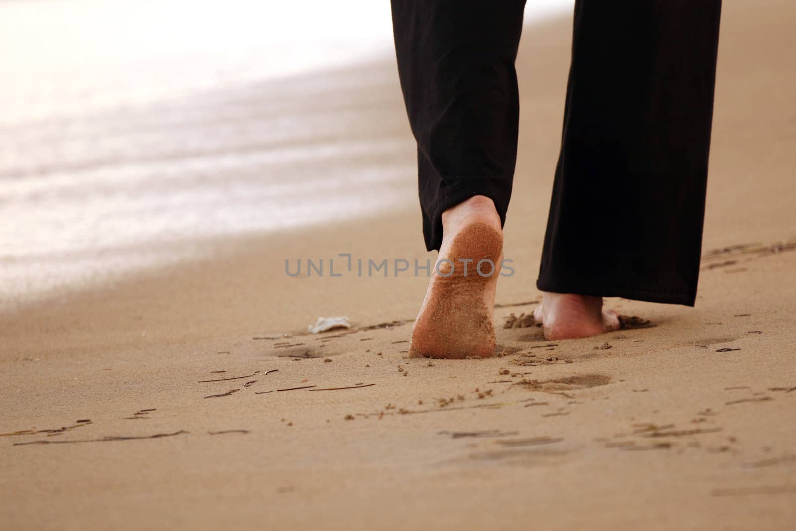 Woman walking on sandbeach in the caribbean