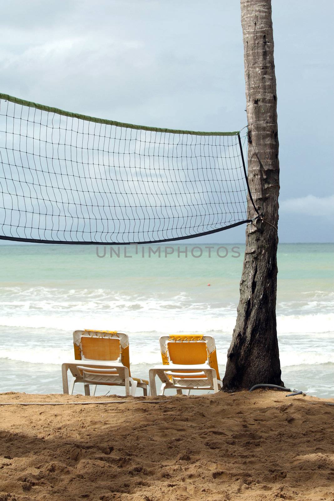 Chaise longues and Volley net on the caribbean beach
