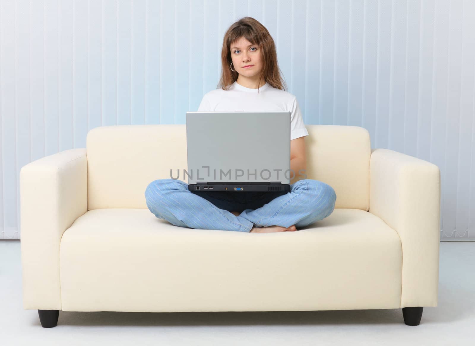 Beauty is sitting on the couch with a laptop