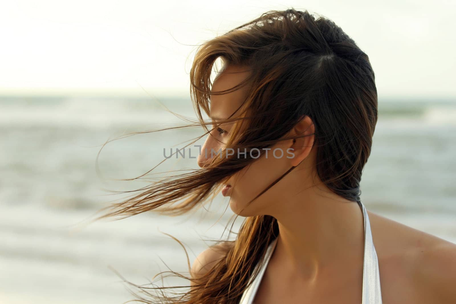 Portrait of woman on the beach by sunset