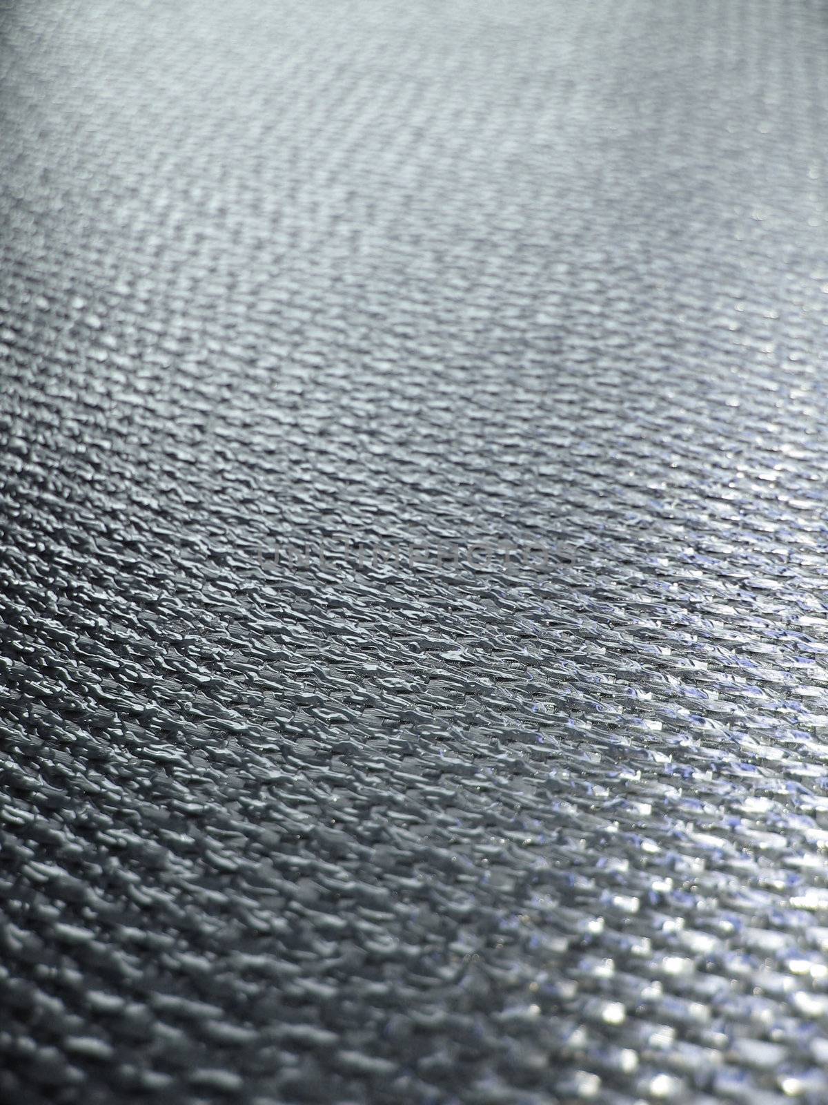 Real carbon fiber in its raw form - this is the material that is used to make durable and strong parts for cars, boats, bikes and more. Shallow depth of field.