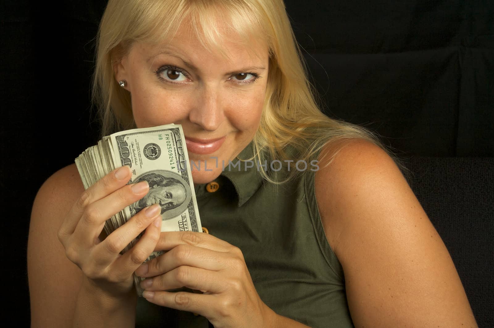 Attractive Woman Excited About her Stack of Money She Holds.