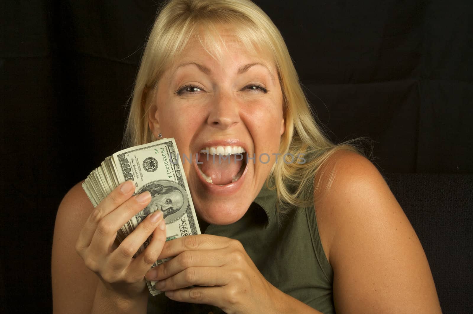 Attractive Woman Excited About her Stack of Money She Holds.