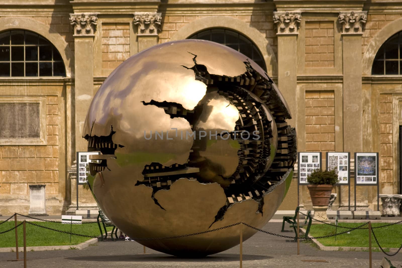 Golden world ball in Vatican with green grass