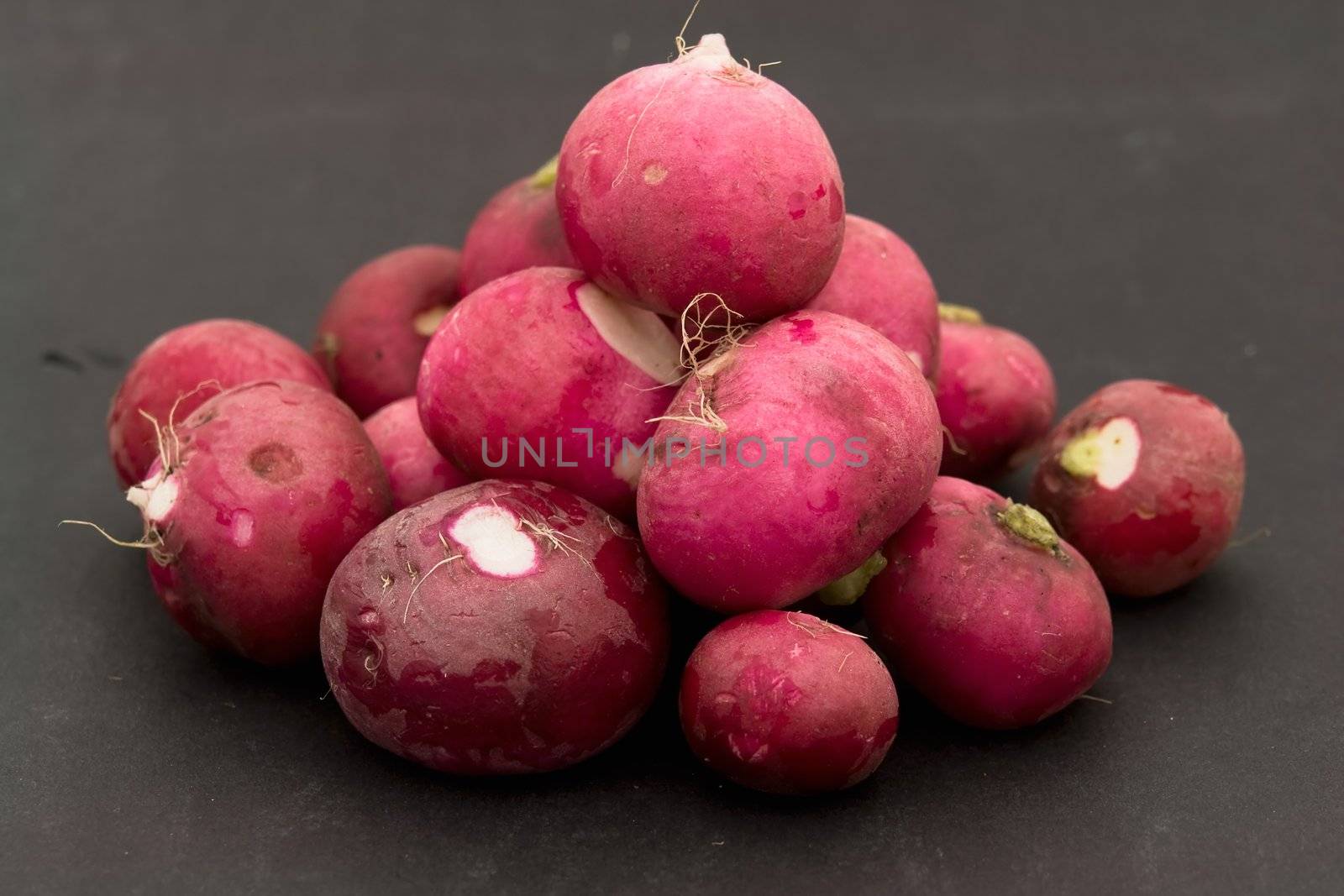 Some garden radishes on a black background