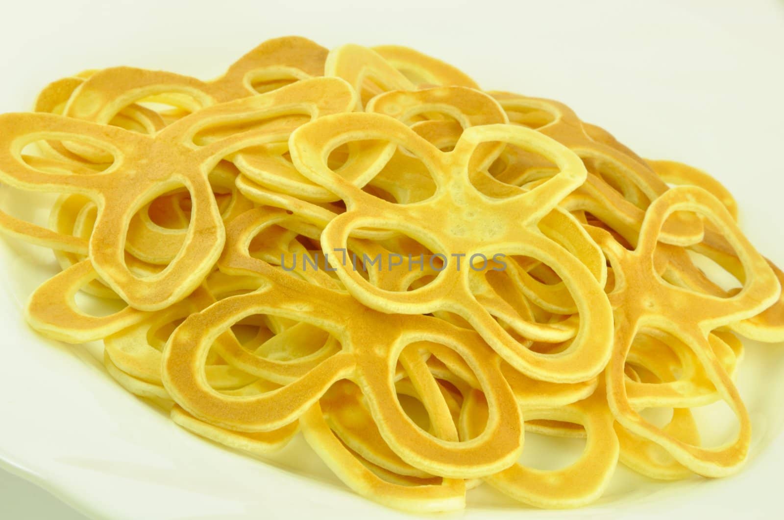 Pancake Flowers Fried from Bater, on White, Close-Up