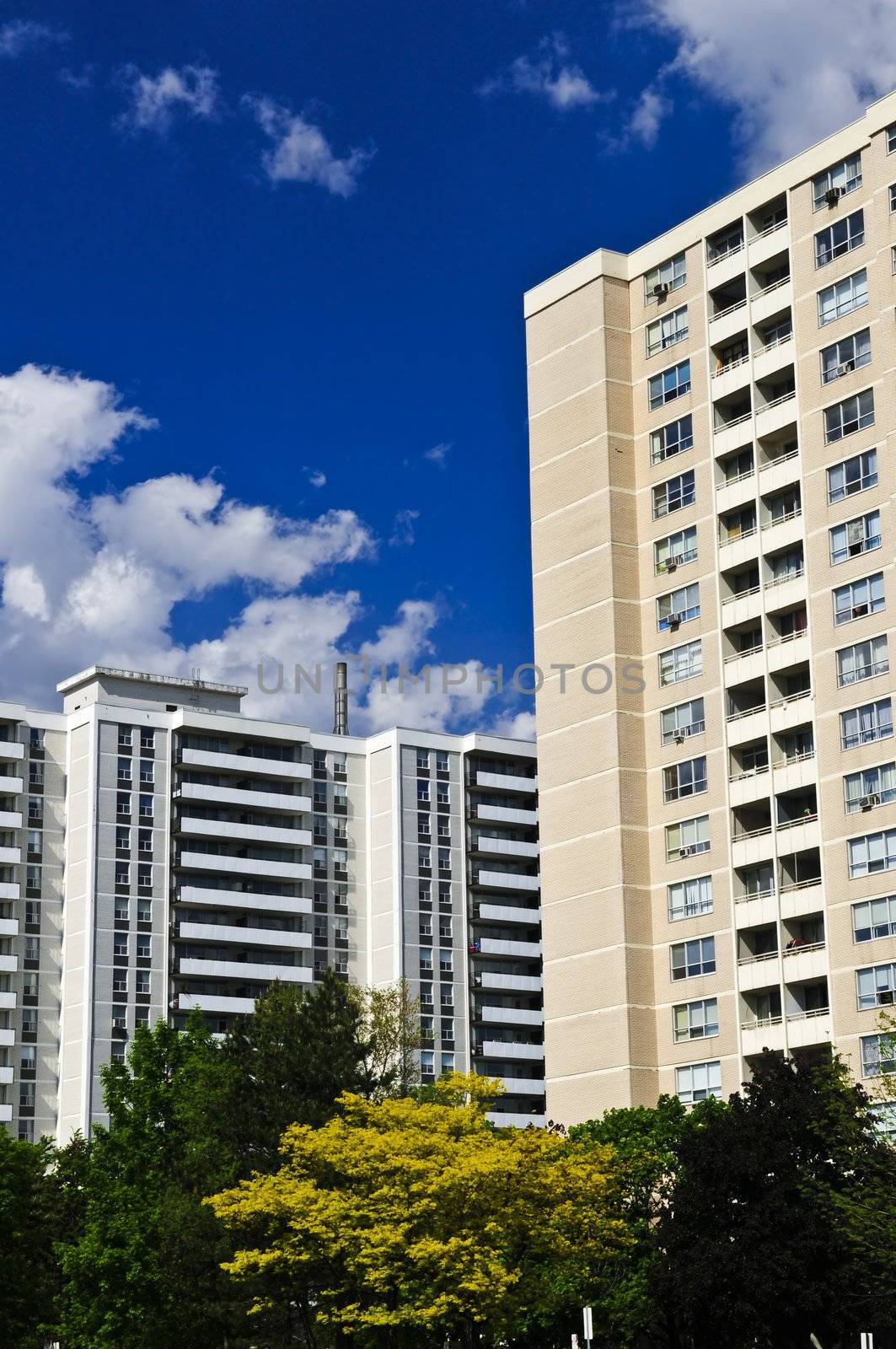 Tall residential apartment buildings with blue sky