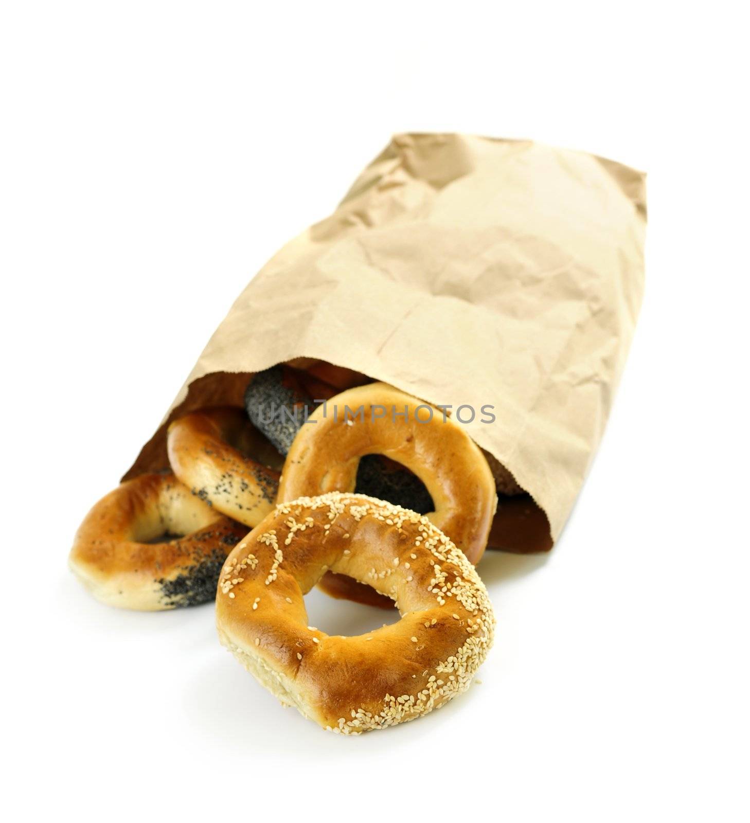 Fresh Montreal style bagels in paper bag on white background