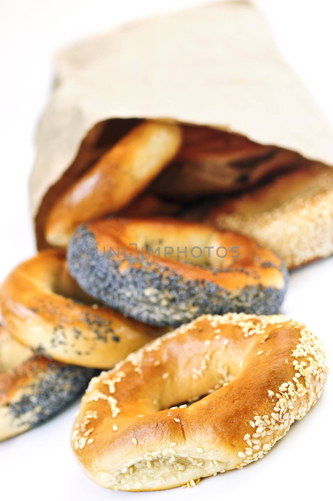 Fresh Montreal style bagels in paper bag on white background