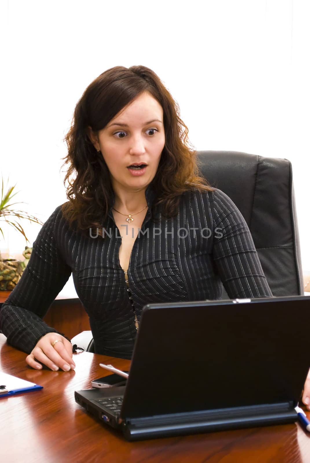 surprised young businesswoman looking at the computer