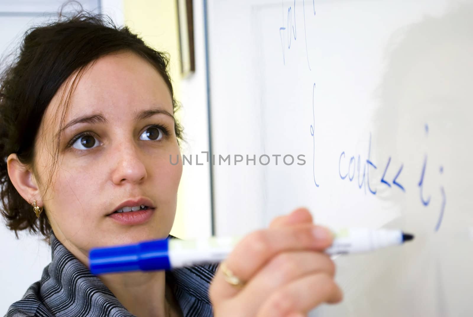 young teacher writing on the white board