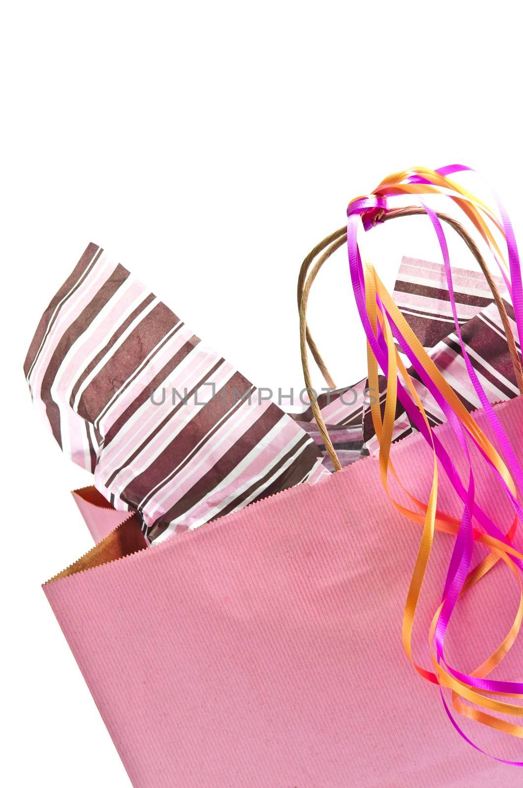 Pink shopping bag with ribbons isolated on white background