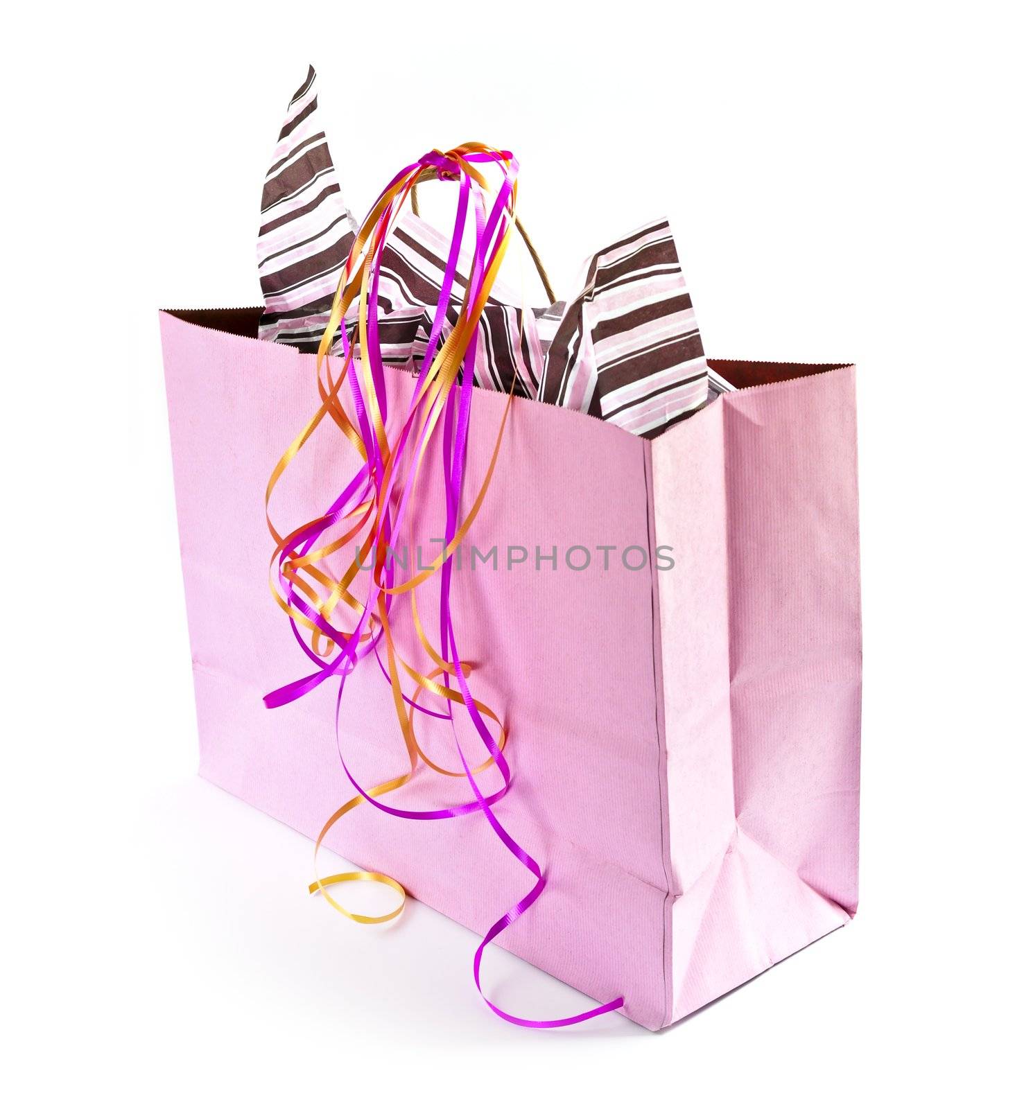 Pink shopping bag with ribbons isolated on white background